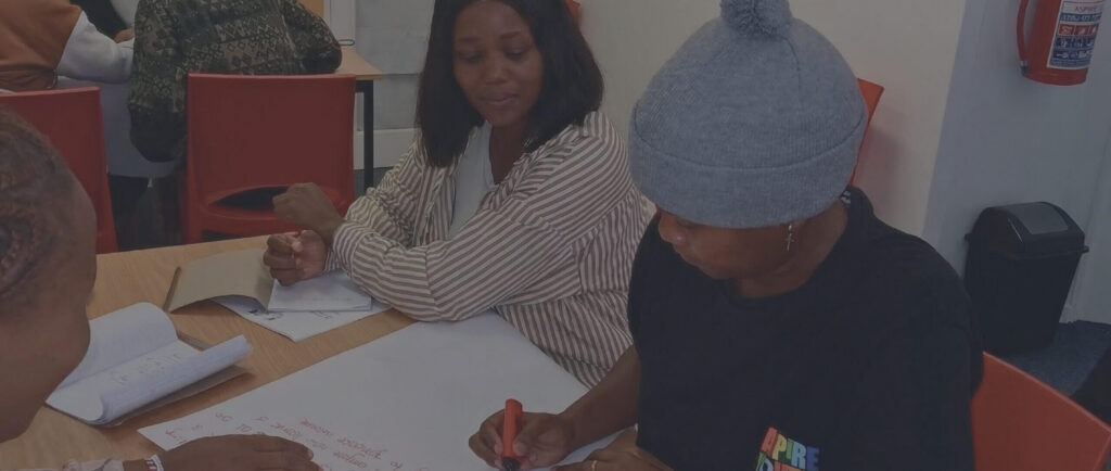 Young people writing notes during an Aspire youth workshop session.